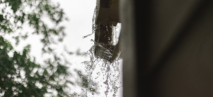 An image of a gutter overflowing with water